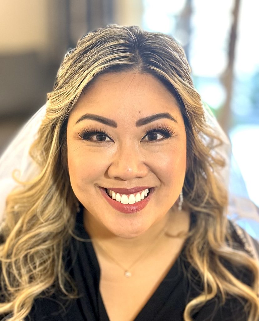 My client's defined eye makeup, long lashes and loose blonde curls.