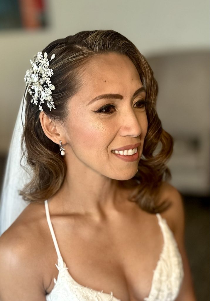 My bridal makeup and shoulder-length waves, finished with a jeweled hair comb and veil.