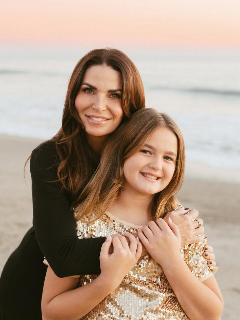 My finished makeup and soft waves on a mother and daughter at the beach at sunset.