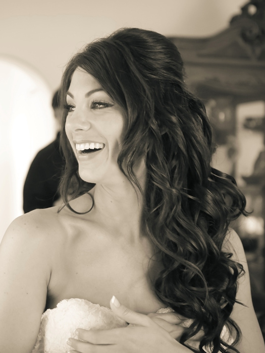 My half-up style with long glossy curls on a laughing bride, in black and white.