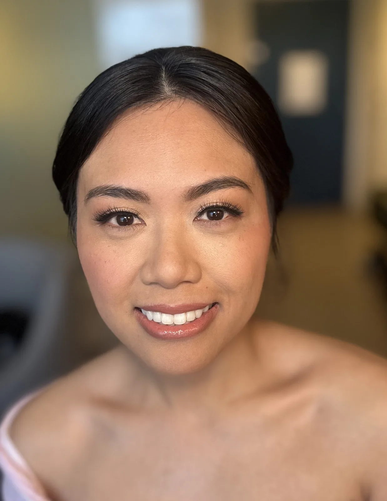 My soft peach bridal makeup on a smiling Alyssa.