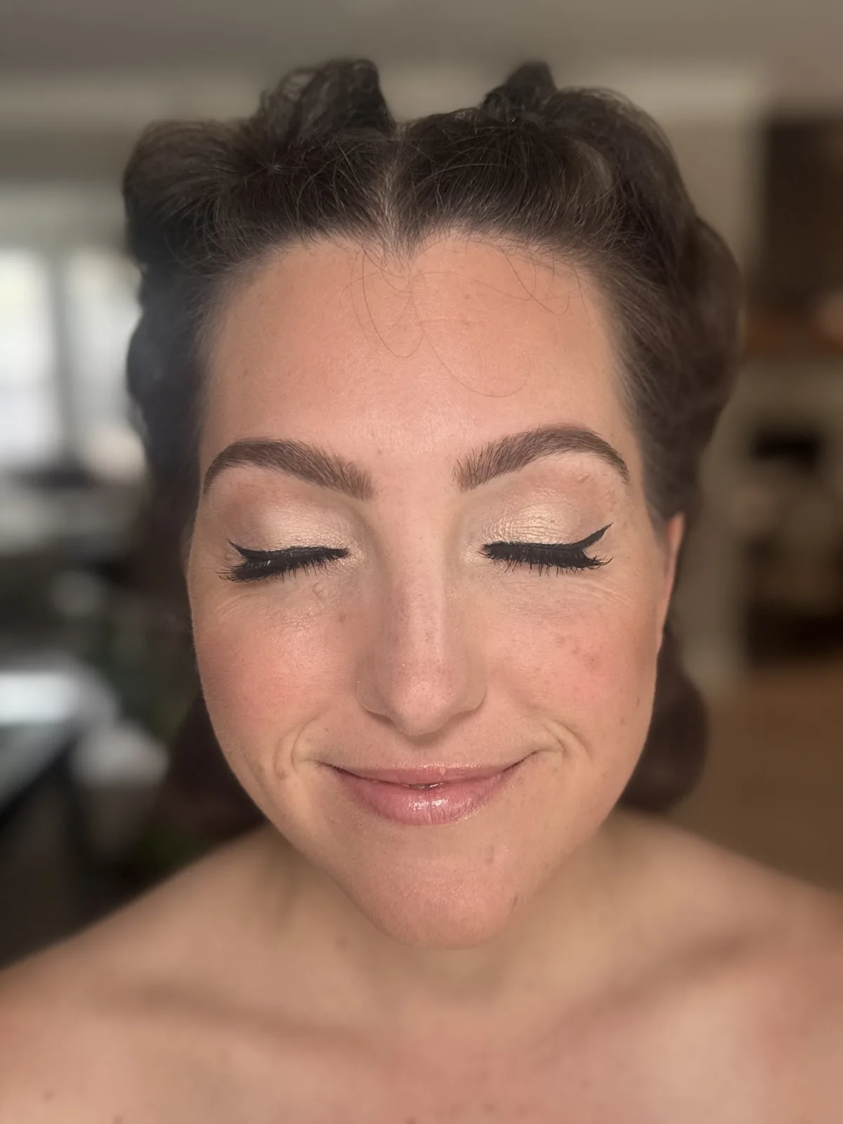 My soft warm eye makeup and winged liner on a client with her eyes closed.