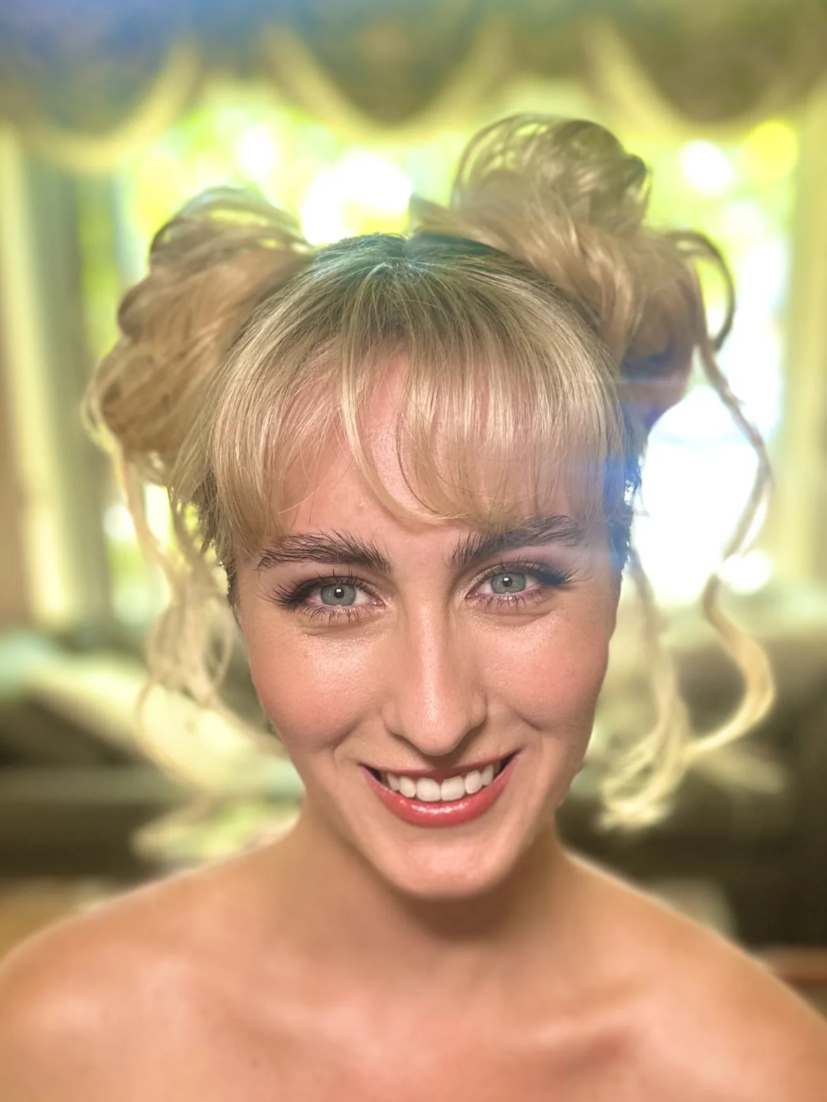 My sun-kissed makeup and playful space buns on Sabrina.