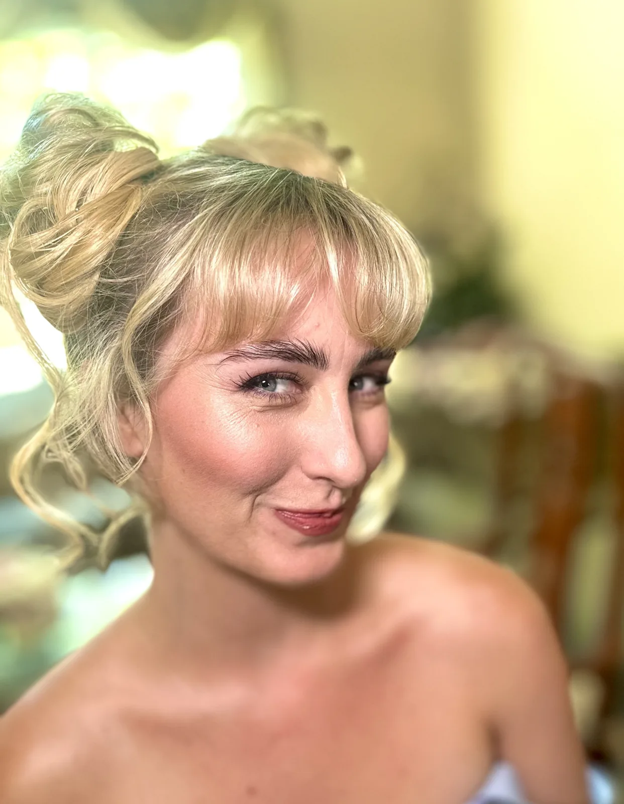 My dewy airbrush makeup and space buns on Sabrina, viewed from the side.