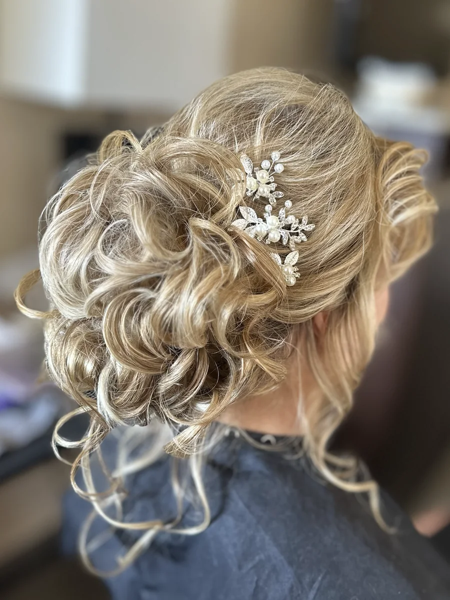 My textured blonde updo with a delicate hair accessory, viewed from behind.