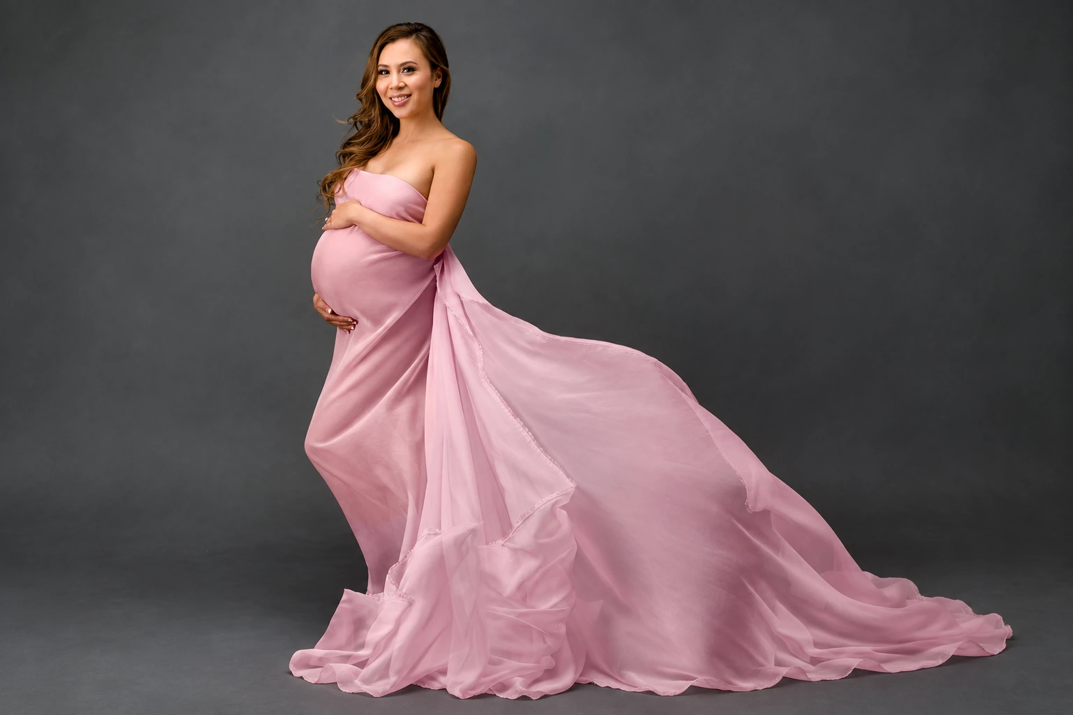 My makeup and hairstyling for a maternity portrait in a flowing pink dress.