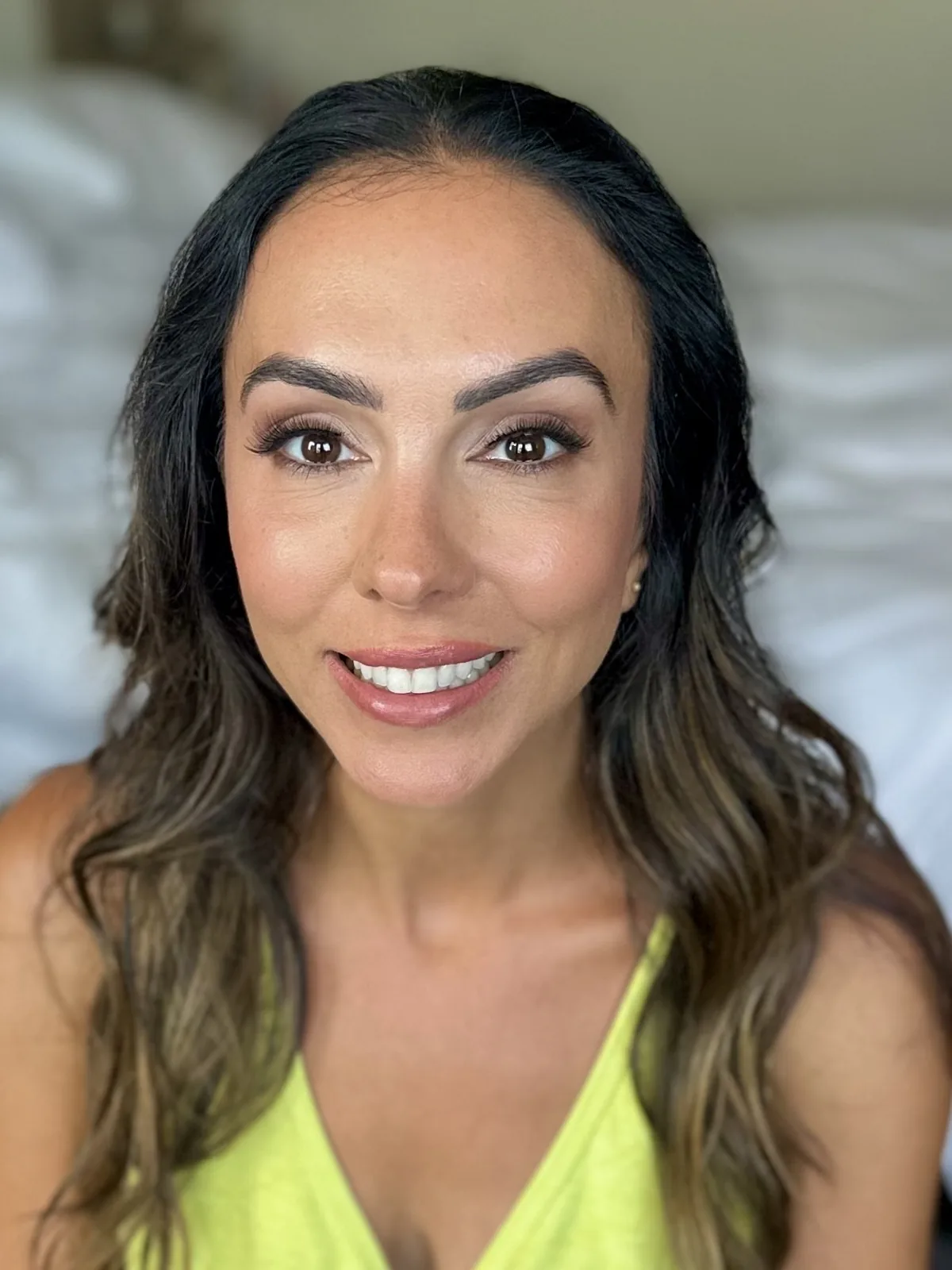 My warm bronzed makeup and soft beach waves on a smiling Jessica.