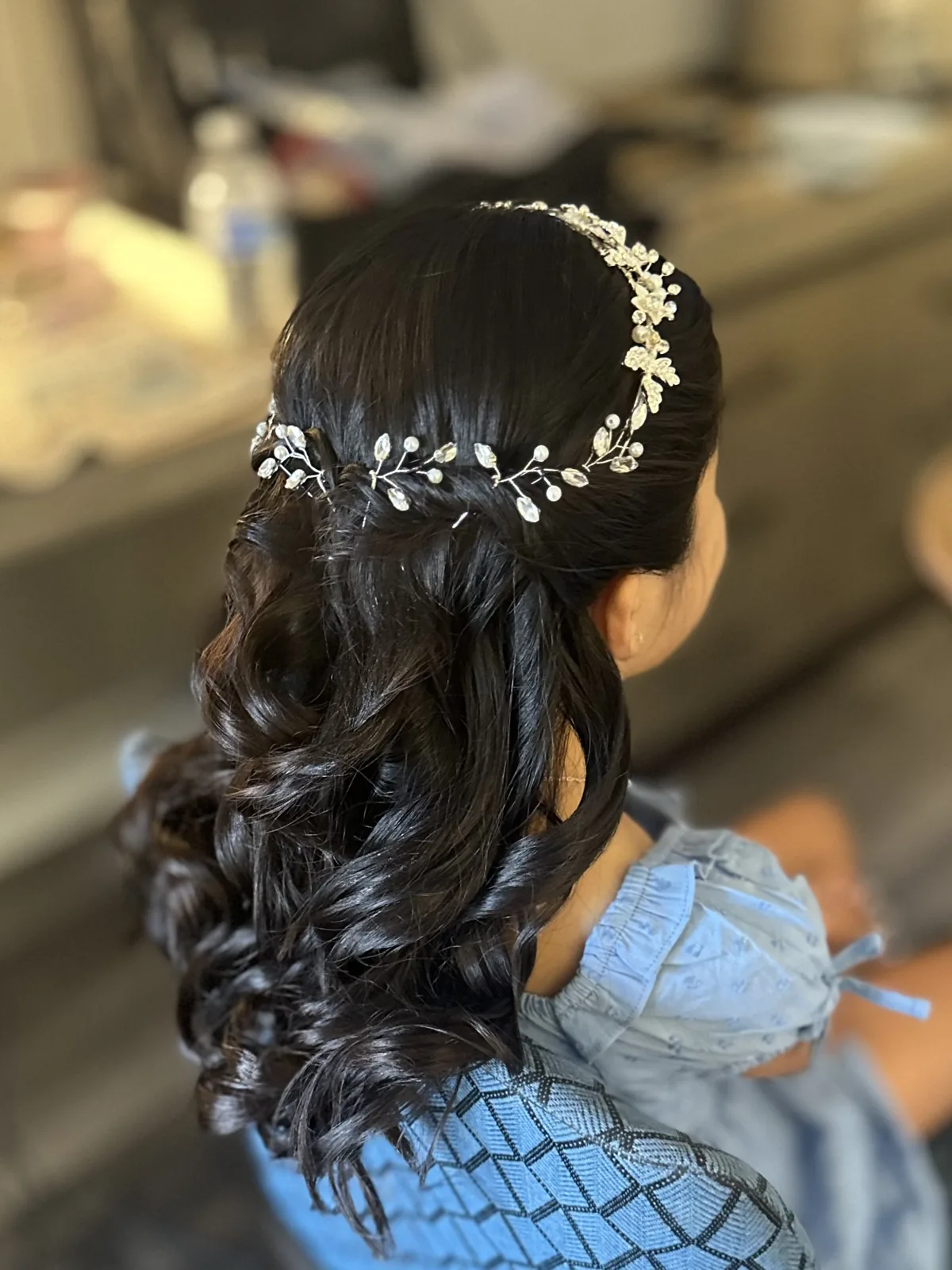 My curled flower-girl hairstyle with a floral crown.